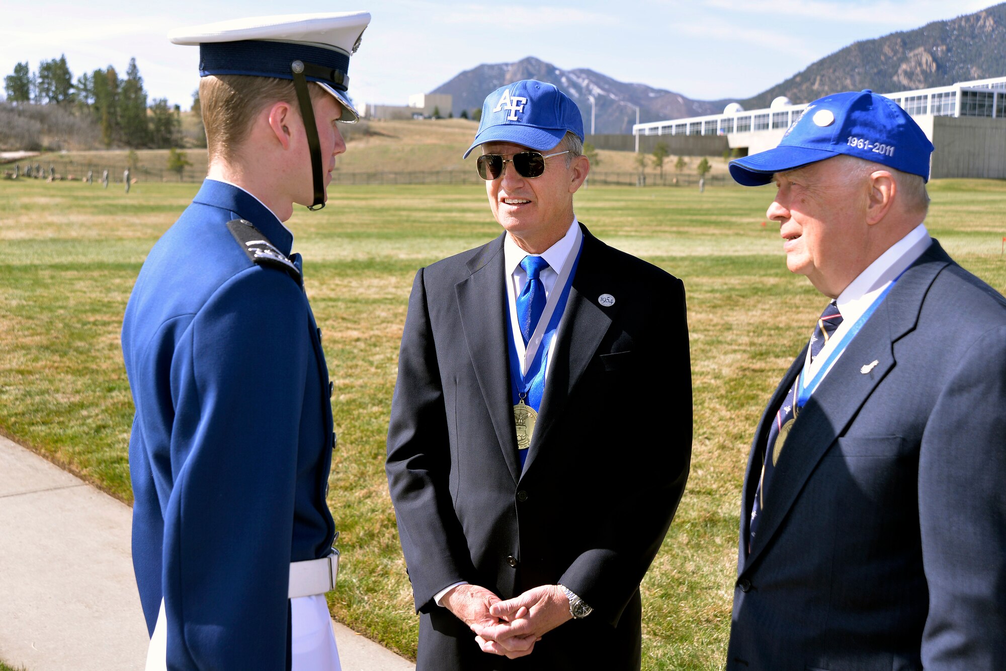 Retired Gen. Kevin Chilton, a 1976 Academy graduate (middle), and Dr. Thomas Eller, a 1961 Academy graduate, chat with a cadet at Stillman Parade Field before the Founders Day Parade here April 11. Chilton and Eller were named the U.S. Air Force Academy Association of Graduates' 2014 distinguished graduates. (U.S. Air Force photo/Bill Evans)