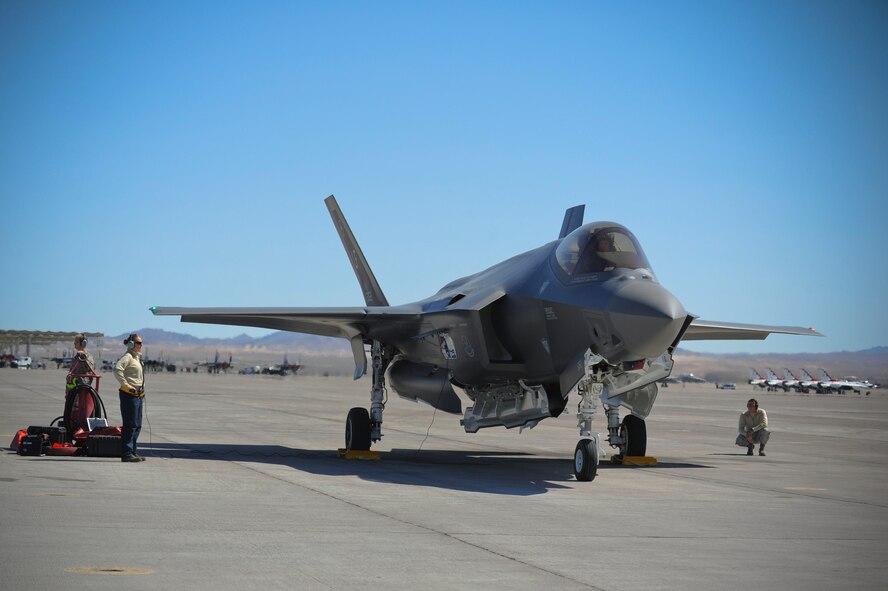 Staff Sgts. Leah Curtin and David Cruson, 61st Aircraft Maintenance Unit Staff F-35 dedicated crew chiefs, run through pre-flight checks of an F-35 Lightning II April 15, 2015 at Nellis Air Force Base, Nevada. (U.S. Air Force photo by Staff Sgt. Darlene Seltmann) 