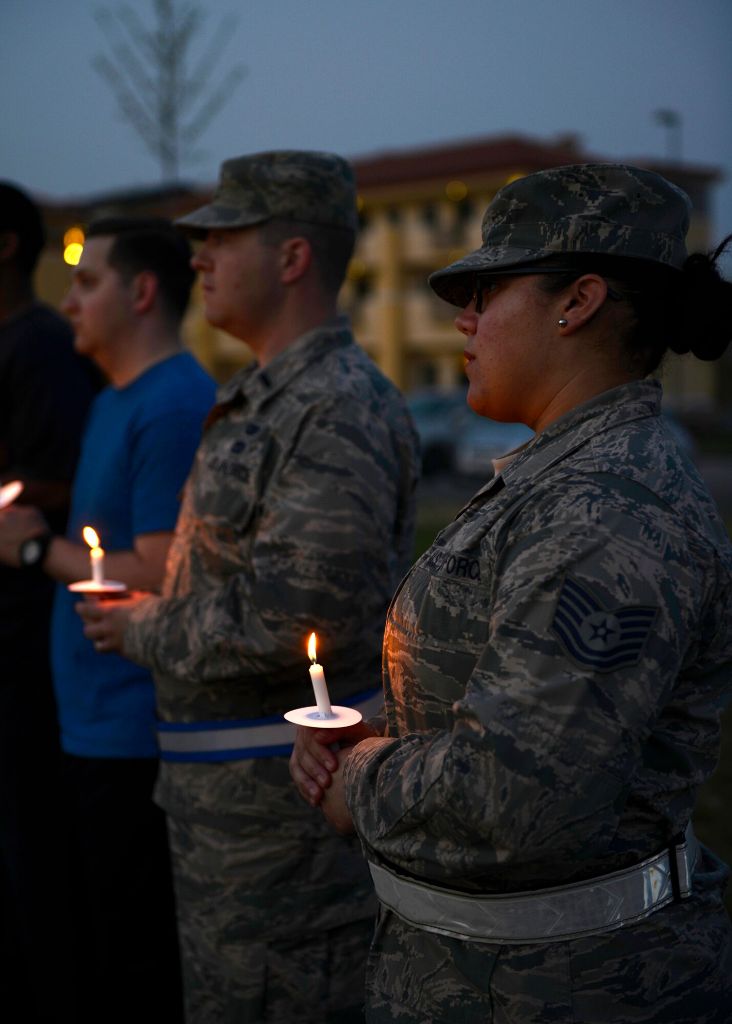 Attendees pay respect during the Holocaust Days of Remembrance candlelight vigil, April 15, 2015, at Aviano Air Base, Italy. The memorial was held in honor of the more than 6 million Jewish people and millions of others who died during the reign of the Nazi Party throughout World War II. (U.S. Air Force photo by Senior Airman Areca T. Wilson/Released)