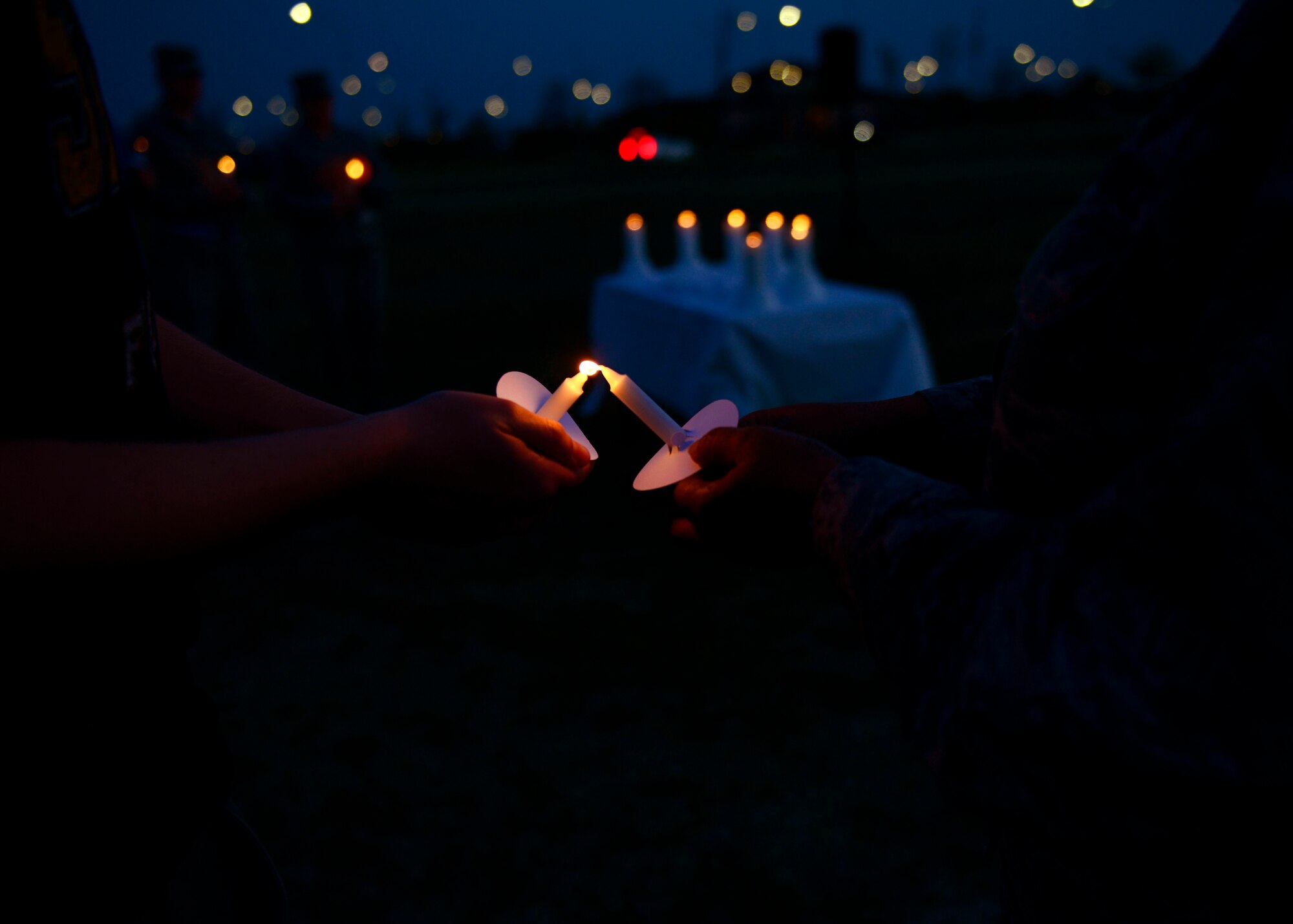 Attendees light candles during the Holocaust Days of Remembrance candlelight vigil, April 15, 2015, at Aviano Air Base, Italy. This year’s vigil commemorated the 70th anniversary of the event and memorialized the approximately six million Jewish people who were killed between 1933 and 1945 during World War II.  (U.S. Air Force photo by Senior Airman Areca T. Wilson/Released)