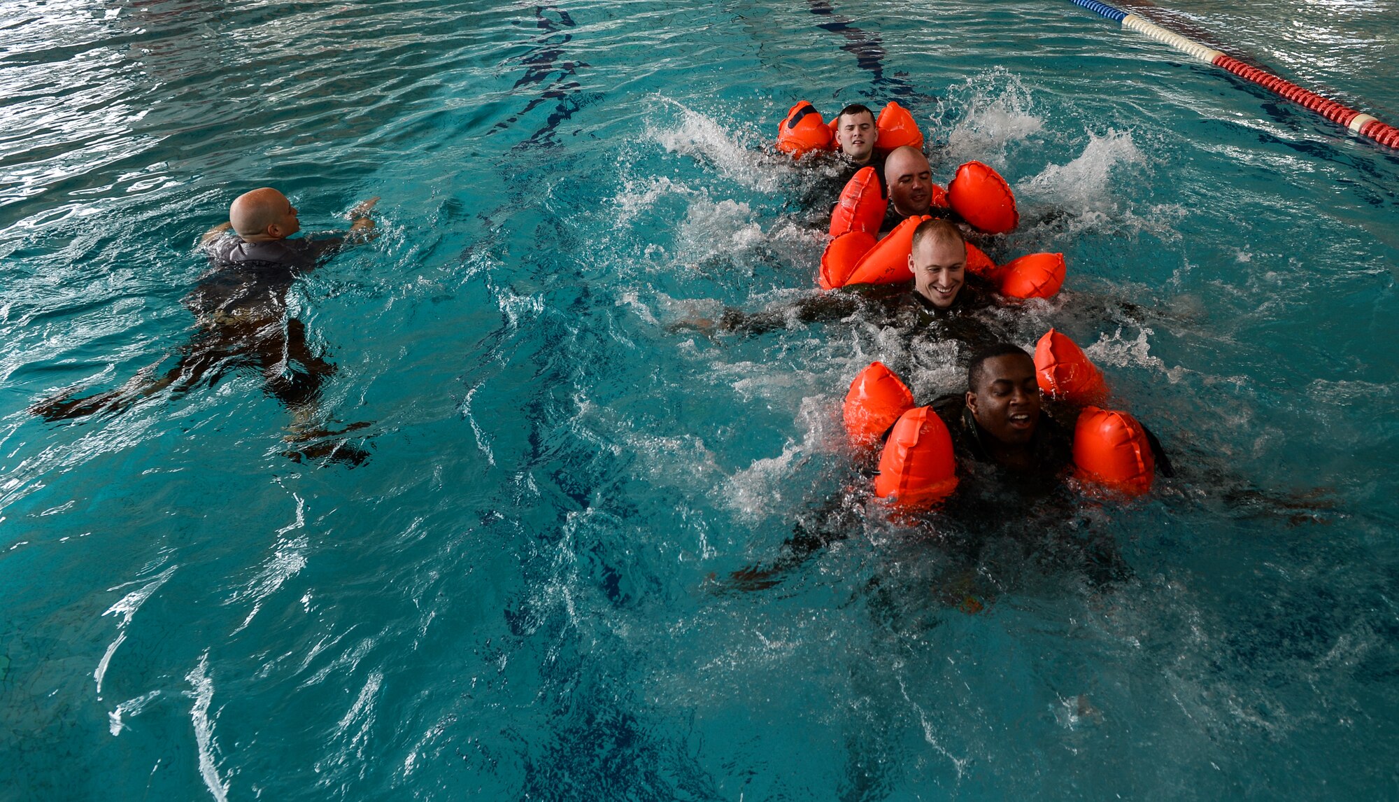 Trainees participate in an exercise during a survival, evasion, resistance and escape water survival course April 13, 2015, at Ramstein Air Base, Germany.  The one-day course provided Airmen from various career specialties training on how to properly react to an emergency situation in the water.  (U.S. Air Force photo/Senior Airman Nicole Sikorski)
