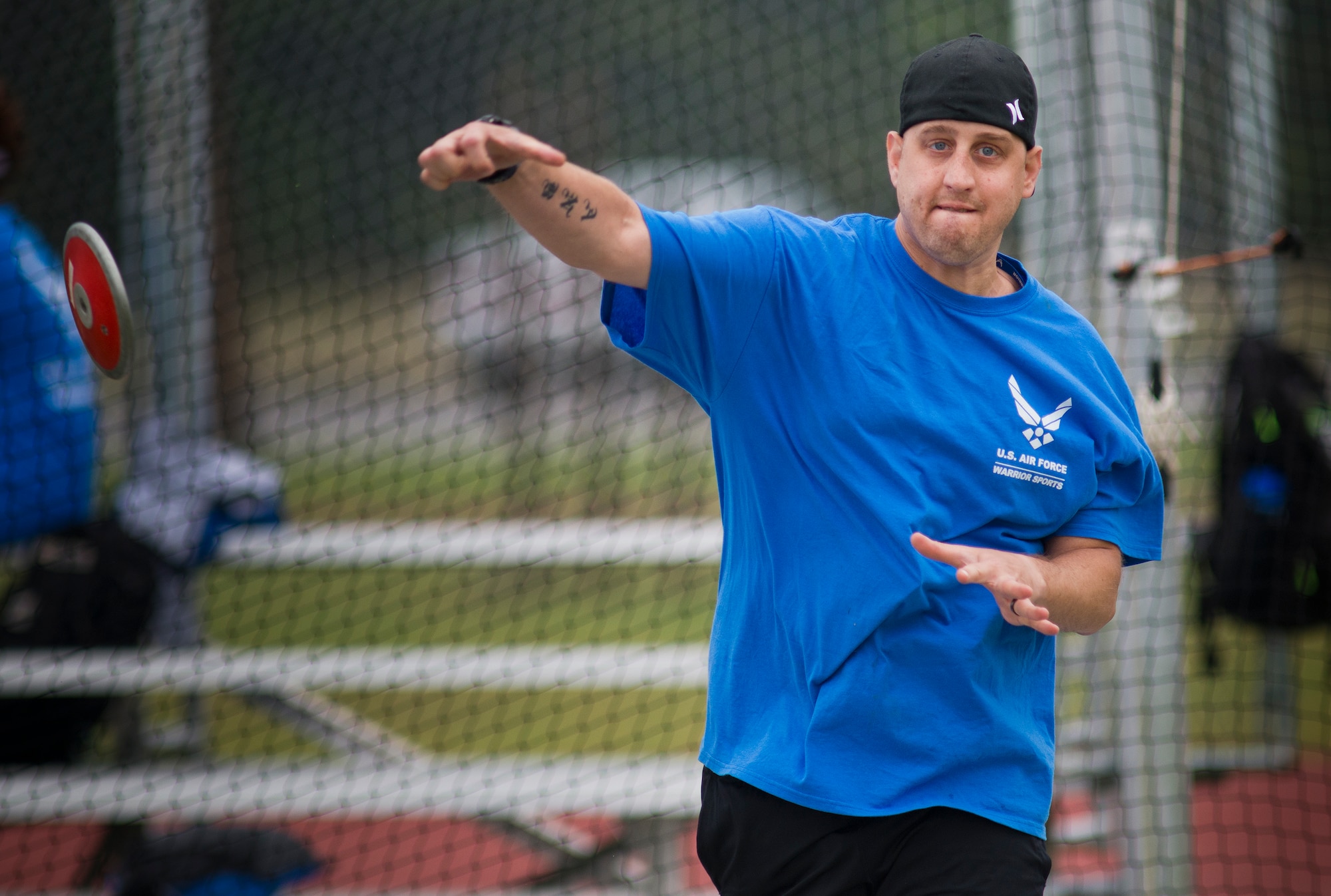 Senior Airman Chris Fugitt, a retired 96th Aircraft Maintenance Squadron Airman and an Air Force Wounded Warrior athlete, lets the discus fly at the track during the second day of an introductory adaptive sports and rehabilitation camp at Eglin Air Force Base, Fla., April 14. Two years after complications from a massive stroke forced Chris to retire from the Air Force, his warrior spirit enabled him to power past a number of debilitating setbacks and attend his first camp.  (U.S. Air Force photo/Samuel King Jr.)