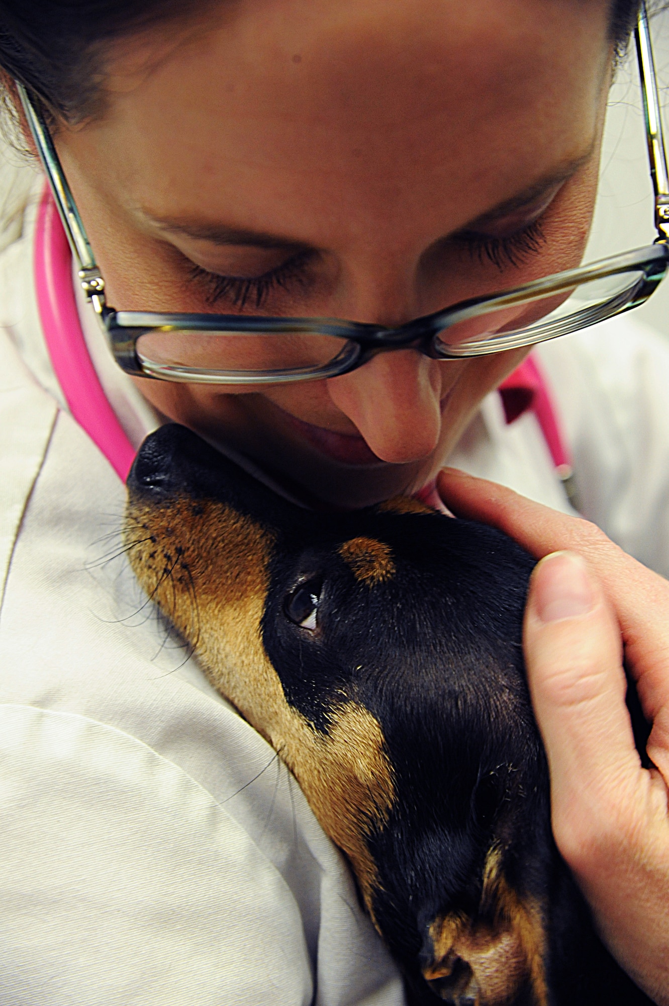 Joanna Kuecker, Vet Clinic veterinarian, holds a patient at Whiteman Air Force Base, Mo., April 1, 2015. The Vet Clinic’s mission is to care for and ensure the patients achieve their desired health. (U.S. Air Force photo by Senior Airman Keenan Berry/Released)