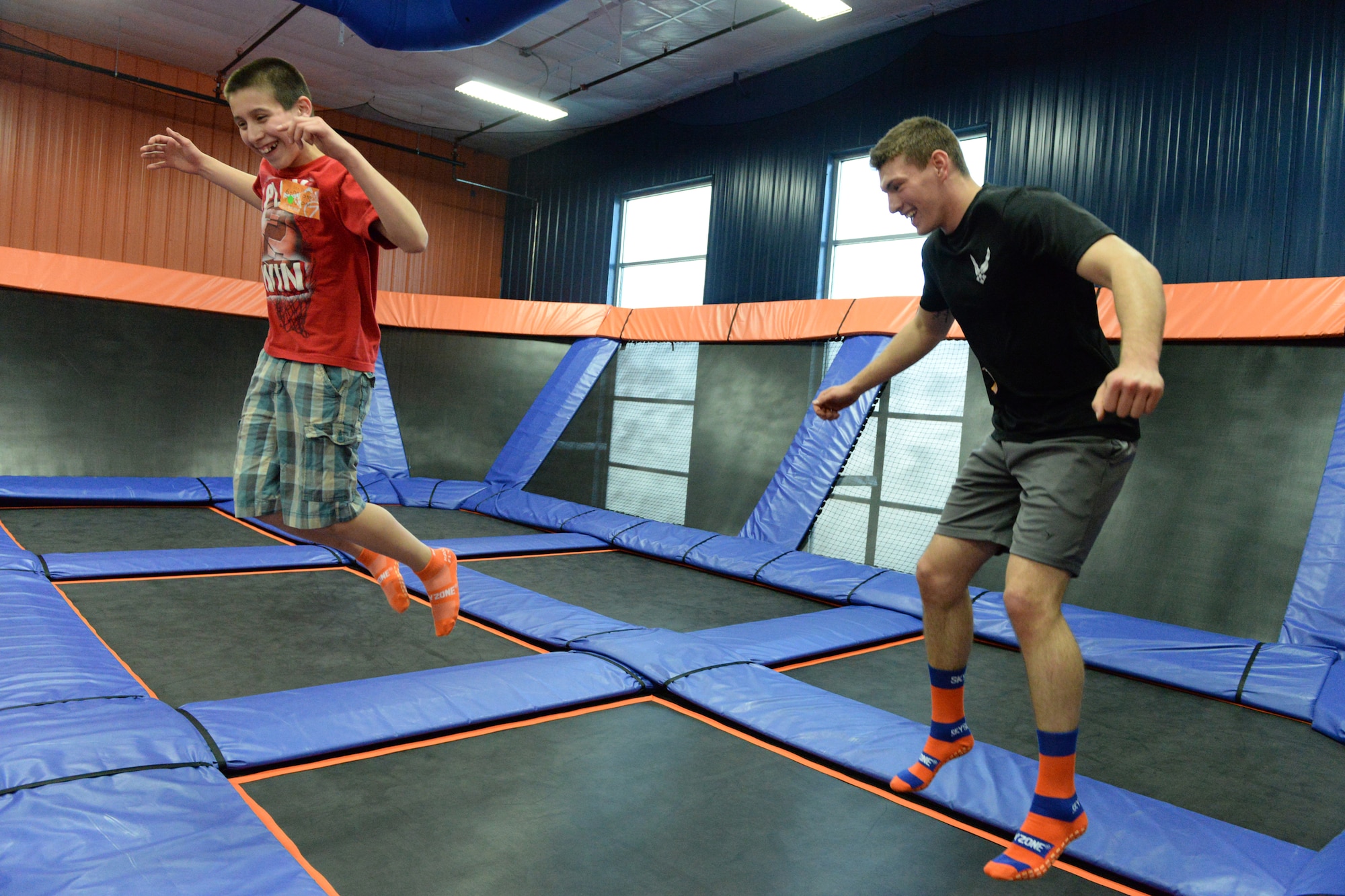 Senior Airman Sean Hummel, of the 119th Wing, right, jumps with his ‘little wingman’ Max during an outing at the Sky Zone indoor trampoline park, Fargo, North Dakota, April 16, 2015. Hummel has been mentoring Max for six years and is working on developing a youth mentoring program for members in the 119th Wing through the North Dakota Air National Guard Family Program called the Little Wingman Program. (U.S. Air National Guard photo by Senior Master Sgt. David H. Lipp/Released)
