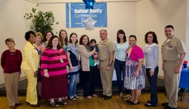 CAPT Timothy Sparks, Joint Base Charleston deputy commander, presents a volunteer appreciation award to Fleet and Family Support Center volunteers, April 16, 2015 at Joint Base Charleston – Weapons Station, S.C. National Volunteer Week (April 12-18, 2015) is a program established by the Points of Light. Points of Light was founded in 1990 by President George H.W. Bush as an independent, nonpartisan, nonprofit organization to encourage and empower the spirit of service. (U.S. Air Force photo/Staff Sgt. AJ Hyatt)