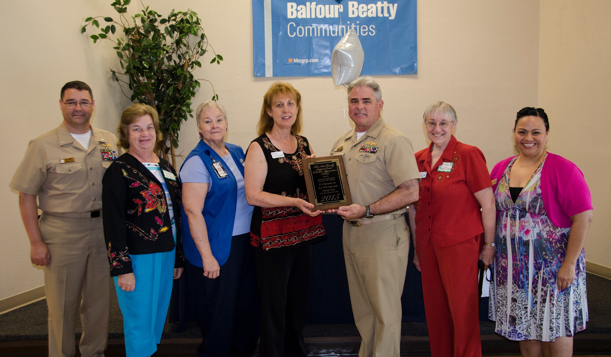 CAPT Timothy Sparks, Joint Base Charleston deputy commander, presents a volunteer appreciation award to the American Red Cross Palmetto S.C. Region volunteers, April 16, 2015 at Joint Base Charleston – Weapons Station, S.C. National Volunteer Week (April 12-18, 2015) is a program established by the Points of Light. Points of Light was founded in 1990 by President George H.W. Bush as an independent, nonpartisan, nonprofit organization to encourage and empower the spirit of service.
 (U.S. Air Force photo/Staff Sgt. AJ Hyatt)
