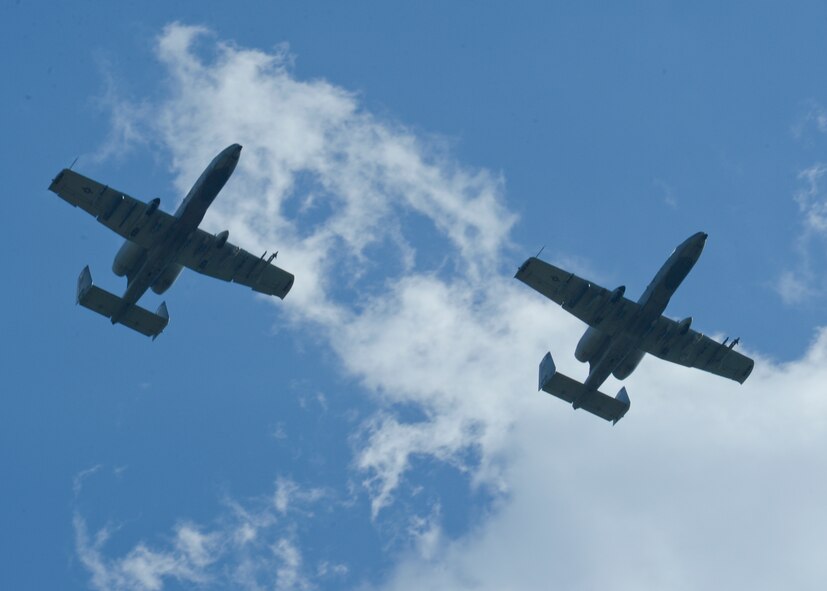 Two U.S. Air Force A-10 Thunderbolt II attack aircraft assigned to the 354th Expeditionary Fighter Squadron fly above the flightline at Campia Turzii, Romania, April 16, 2015. The U.S. and Romanian air forces will conduct training aimed to strengthen interoperability and demonstrate the countries' shared commitment to the security and stability of Europe. (U.S. Air Force photo by Staff Sgt. Joe W. McFadden/Released)