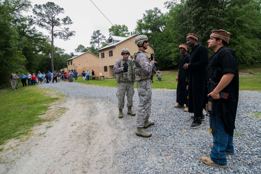 An 820th Base Defense Group fire team speaks with simulated foreign natives during a military operations in urban terrain demonstration for the 2015 Safeside Reunion April 11, 2015, at Moody Air Force Base, Ga. The fireteam built rapport with the natives to show Safeside Association members their intelligence gathering capability. (U.S. Air Force photo by Airman 1st Class Dillian Bamman/Released)