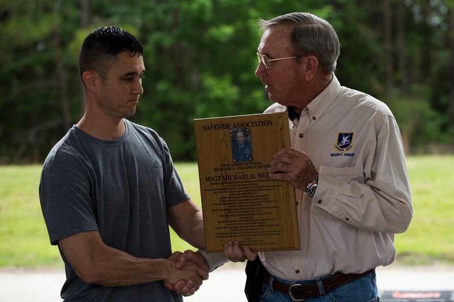 U.S. Air Force retired Brig. Gen. Richard A. Coleman, right, former director of Security Forces, Headquarters U.S. Air Force, presents an award to Master Sgt. Michael Murphy, 822d Base Defense Squadron, during the 2015 Safeside Reunion April 11, 2015, at Moody Air Force Base, Ga. The Safeside Association established the Gen. Coleman award to recognize past and present defenders who showed heroism in the line of duty. (U.S. Air Force photo by Airman 1st Class Dillian Bamman/Released)
