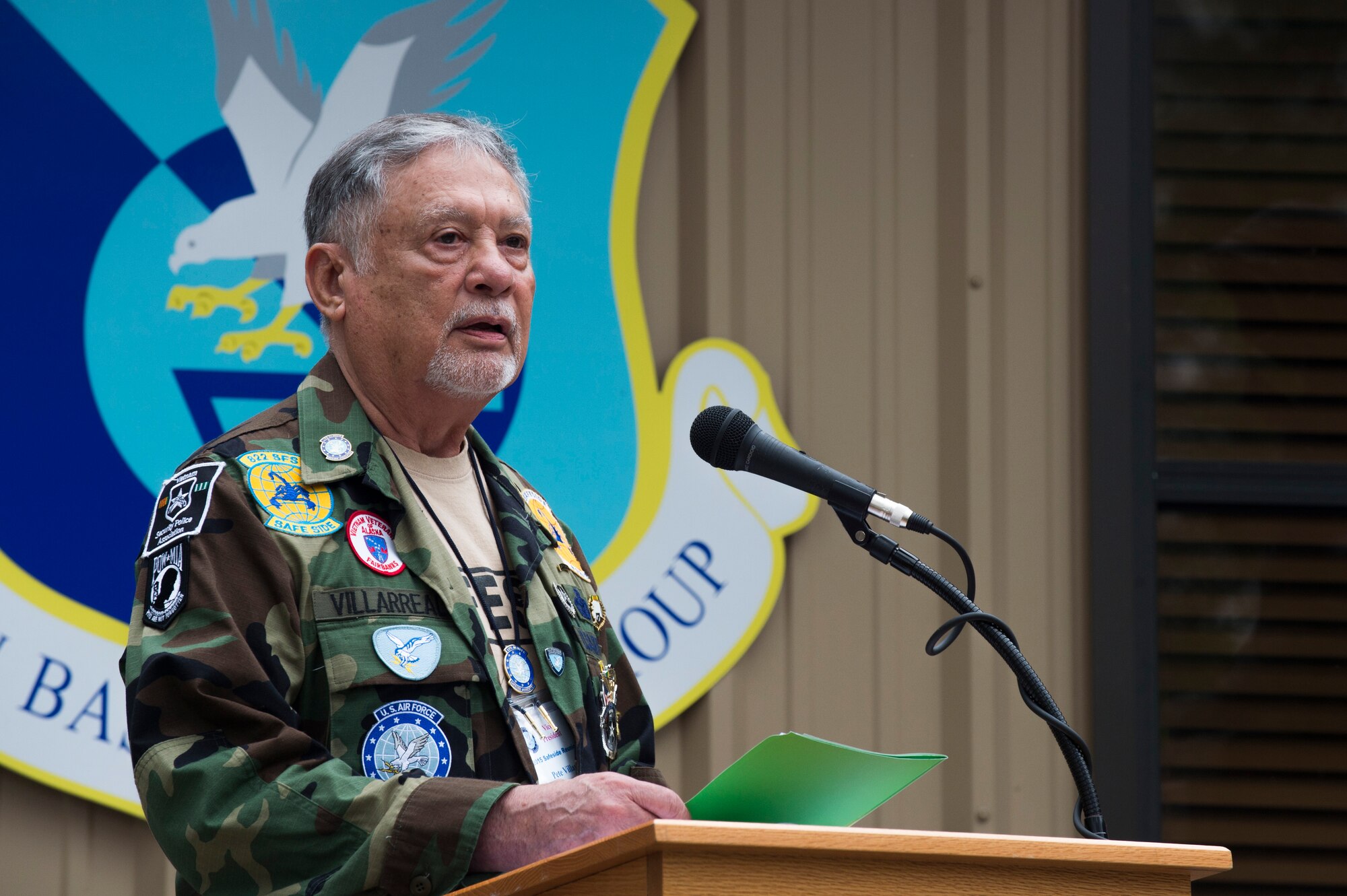 U.S. Air Force retired Senior Master Sgt. Pete Villarreal, Safeside Association vice president, speaks during a memorial ceremony for the 2015 Safeside Reunion April 11, 2015, at Moody Air Force Base, Ga.  Retired Brig. Gen. Richard A. Coleman, former director of Security Forces, Headquarters U.S. Air Force, presented Villareal the Gen. Coleman Award for his contributions to Operation Safeside and the Safeside Association. (U.S. Air Force photo by Airman 1st Class Dillian Bamman/Released)
