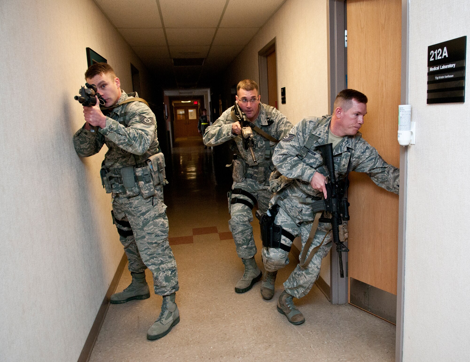 U.S. Air Force Tech. Sgt. Steve Thompson, Tech. Sgt. Gregory Oberfield and Tech. Sgt. Brandon Ostrowsky, with the 121st Security Forces Squadron, perform close quarter search and clear maneuvers in response to a simulated active shooter during a training exercise April 15, 2015 at Rickenbacker Air National Guard Base, Ohio. The training exercise was held to test the reactions of military members and the response time of security forces personnel. (U.S. Air National Guard photo by Tech. Sgt. Zachary Wintgens/Released)
