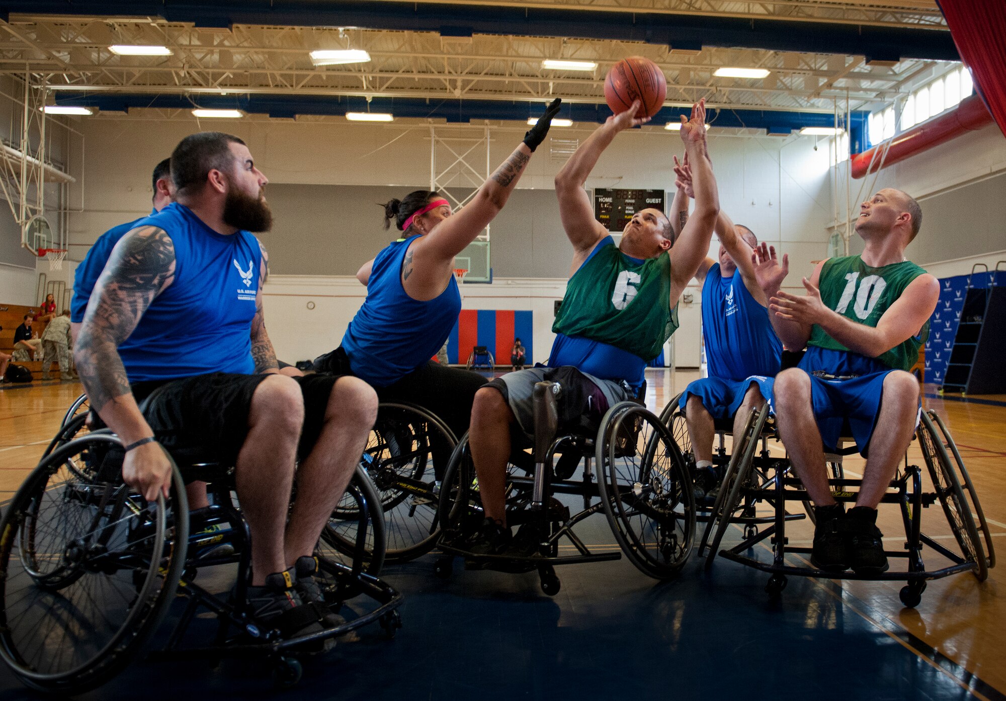 Brian Williams, an Air Force Wounded Warrior athlete, takes a shot at the basket at a wheelchair basketball scrimmage during the fourth day of an introductory adaptive sports and rehabilitation camp at Eglin Air Force Base, Fla., April 16. The DOD’s military adaptive sports program enhances warrior recovery by engaging wounded, ill and injured service members in ongoing, daily adaptive activities, based on their interest and ability. (U.S. Air Force photo/Samuel King Jr.)