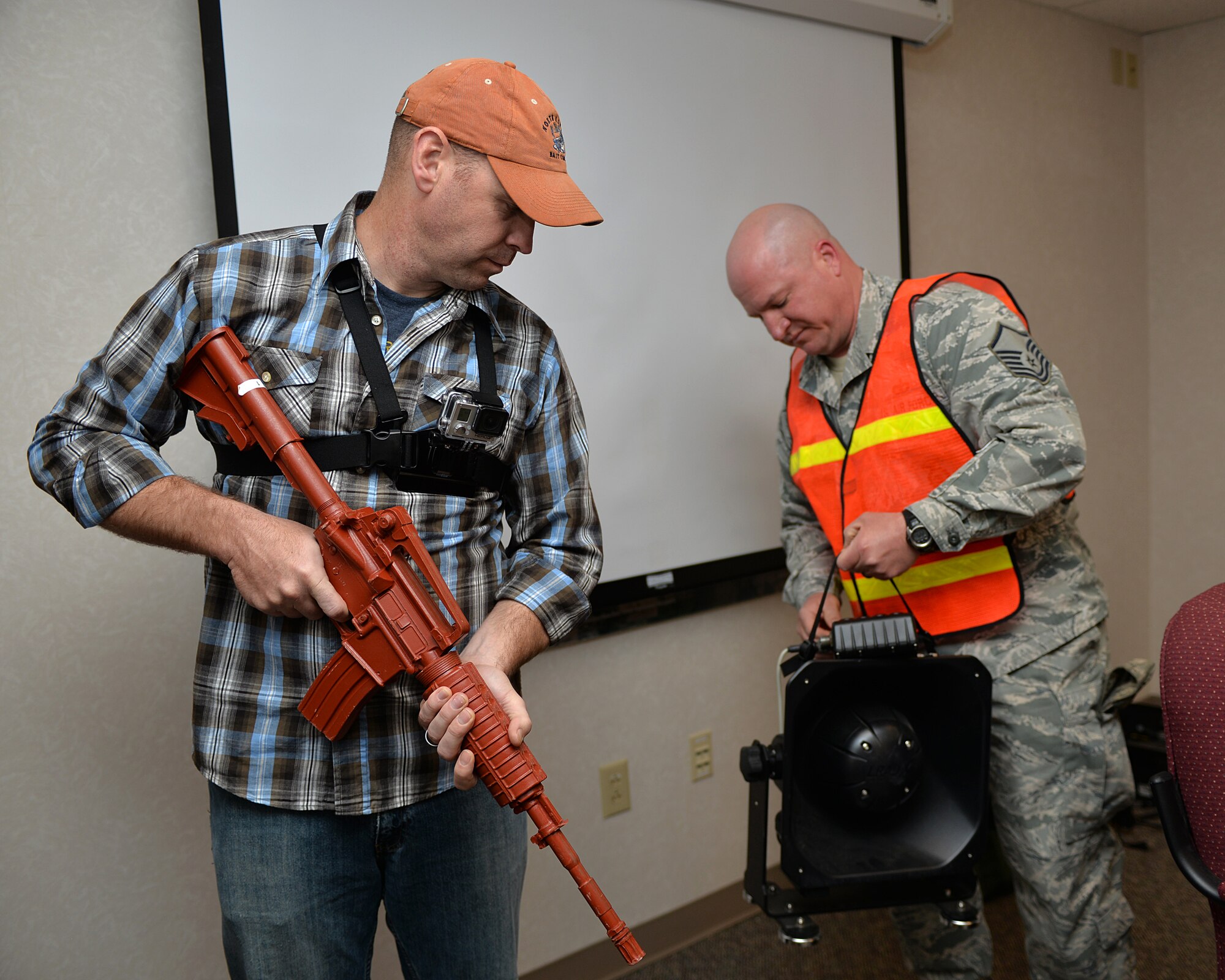 U.S. Air Force Senior Master Sgt. Richard Gay, superintendent with the 121st Inspector General's Office, prepares to simulate an active shooter with Master Sgt. Charles Ferrell, non-commissioned officer in charge of plans and programs with the 121st Security Forces Squadron, April 15, 2015 at Rickenbacker Air National Guard Base, Ohio. The training exercise was held to test the reaction of military members and the response time of security forces. (U.S. Air National Guard photo by Airman Ashley Williams/Released)