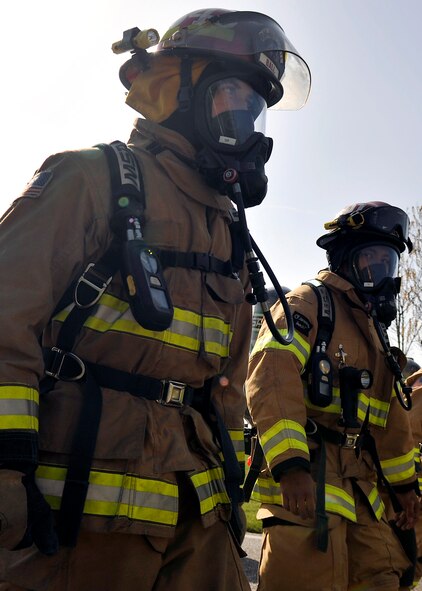 Firefighters from the 100th Civil Engineer Squadron Fire Department march together during a Holocaust Remembrance ruck march and monthly wing 5K run April 16, 2015, on RAF Mildenhall, England. The ruck was held in honor of Holocaust Remembrance Week, and Team Mildenhall came together to show their support. (U.S. Air Force photo by Airman 1st Class Kyla Gifford/Released)