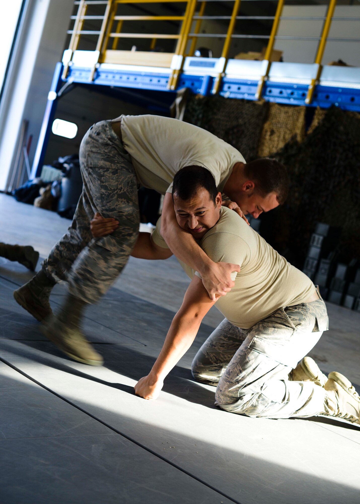 From left, U.S. Air Force Staff Sgt. Joshua Ferguson and Staff Sgt. Rodrigo Regalado, 31st Security Forces Squadron training instructors, perform grappling techniques during a week-long combat expertise training program, April 13, 2015, at Aviano Air Base, Italy. Airmen learned multiple ways to disengage from assailants with proper use of force. (U.S. Air Force photo by Senior Airman Austin Harvill/Released)