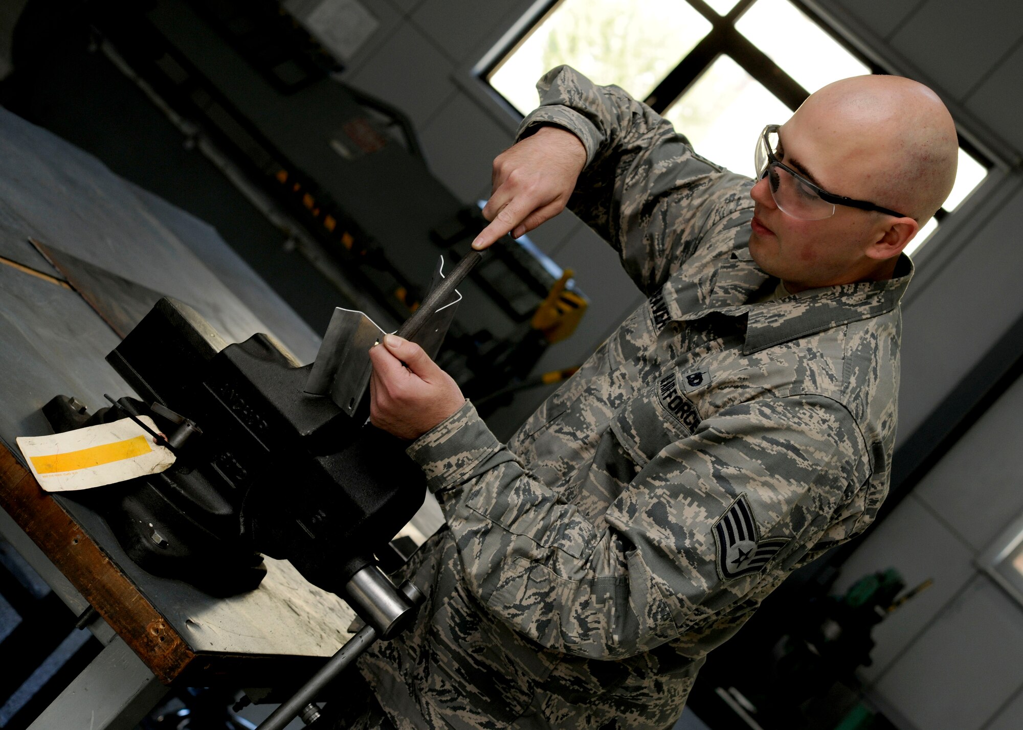 Staff Sgt. Travis Weaver, 39th Maintenance Squadron sheet metal aircraft structural maintenance craftsman, forms sheet metal into a bracket April 6, 2015, at Incirlik Air Base, Turkey. The sheet metal shop performs many functions on base including helping with maintenance and repairs for the 39th Civil Engineer Squadron. (U.S. Air Force photo by Senior Airman Krystal Ardrey/Released)  
