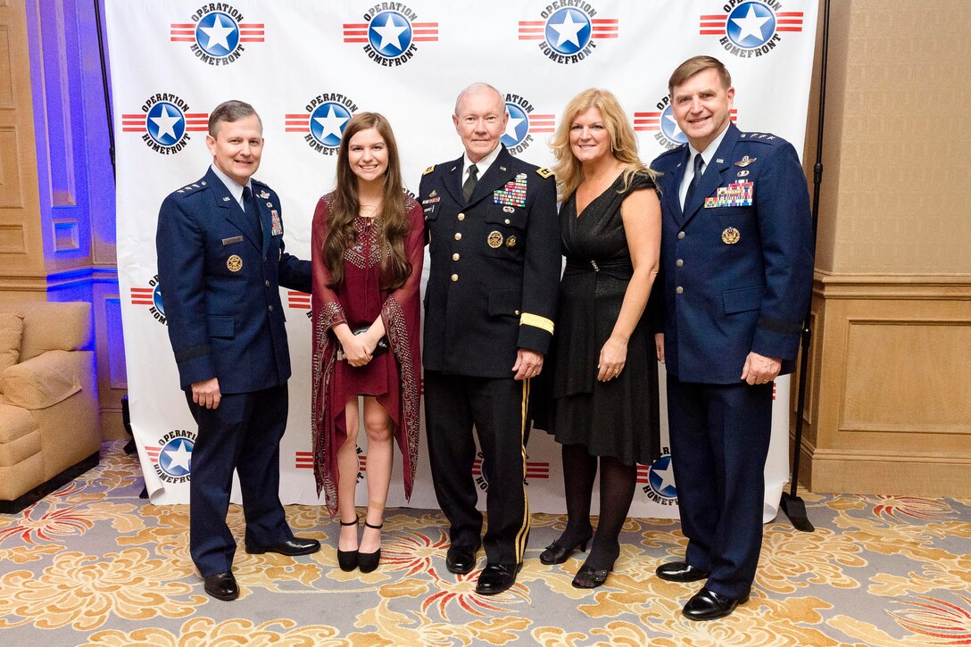 Army Gen. Martin E. Dempsey, center, chairman of the Joint Chiefs of Staff, poses for a photograph with family members of Air Force Child of the Year nominee Sarah Francesca Hesterman, red dress, and Air Force Lt. Gen. Stephen L. Hoog during the annual Military Child of the Year awards gala in Arlington, Va., April 16, 2015.