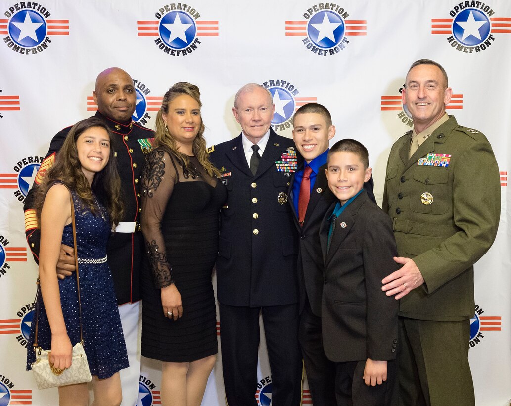 Army Gen. Martin E. Dempsey, center, chairman of the Joint Chiefs of Staff, poses for a photograph with family members of Marine Corps Child of the Year nominee Christopher-Raul Rios Rodriguez, red tie, and Marine Corps Maj. Gen. James W. Lukeman during the annual Military Child of the Year awards gala in Arlington, Va., April 16, 2015.