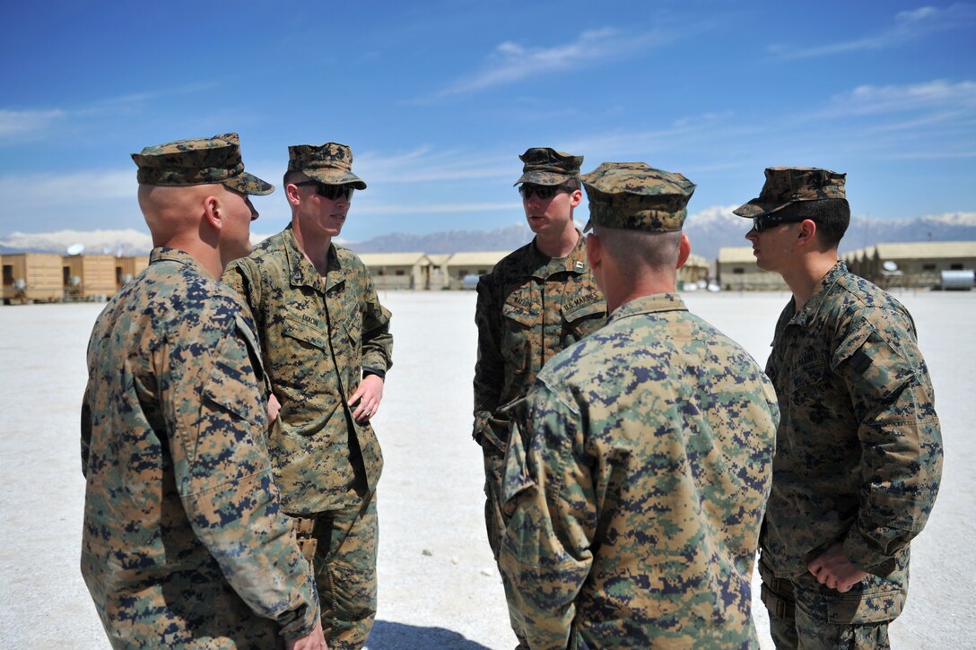 U.S. Marine Corps Capt. Maurice Naylon, center, U.S. Marine Corps 1st Lt. Andrew Dixon and other Marines discus their mission before training Afghan military policemen on infantry tactics and techniques at the Afghan Military Police Guard Compound in Parwan province, Afghanistan, April 5, 2015. Naylon, Dixon and the other Marines are assigned to the Georgian Deployment Program.