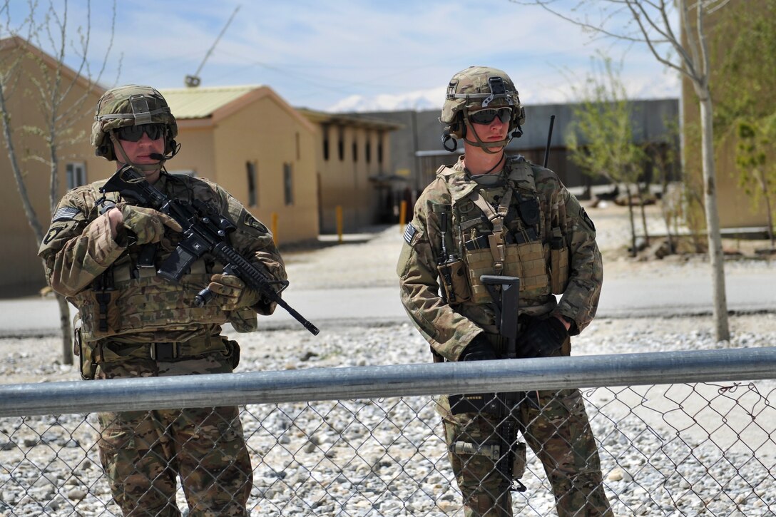 U.S. soldiers provide security while U.S. Marines train Afghan military policemen on infantry tactics and techniques at the Afghan Military Police Guard Compound in Parwan province, Afghanistan, April 5, 2015.