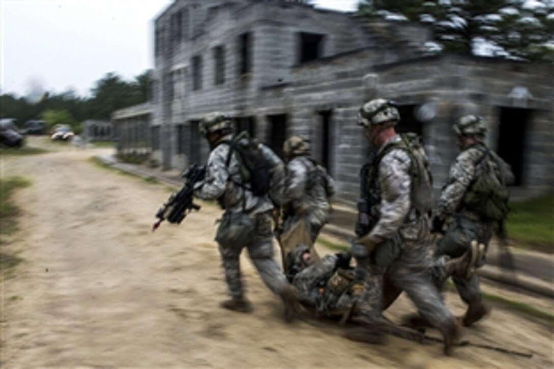 Soldiers move a simulated casualty from one building to another as part of the Combined Joint Operational Access Exercise 15-01 on Fort Bragg, N.C., April 15, 2015,. The soldiers are assigned to the 82nd Airborne Division's 2nd Brigade Combat Team. 
