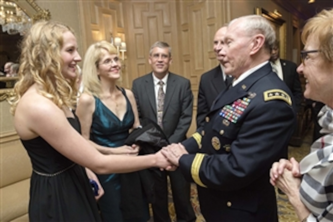 Army Gen. Martin E. Dempsey, chairman of the Joint Chiefs of Staff, meets Emily Elizabeth Kliewer, Navy Child of the Year nominee, during the annual Military Child of the Year awards gala in Arlington, Va., April 16, 2015. The event recognizes outstanding military children representing each of the service branches.
