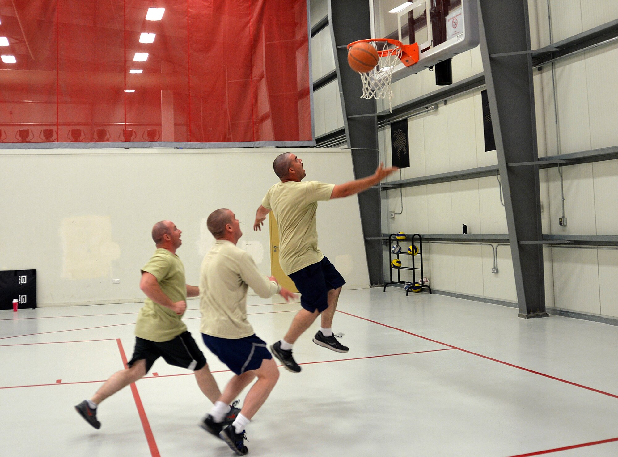 Fitness center patrons play basketball in the gym at an undisclosed location in Southwest Asia April 17, 2015. The fitness center is available to base personnel 24/7 here. (U.S. Air Force photo/Tech. Sgt. Jeff Andrejcik) 