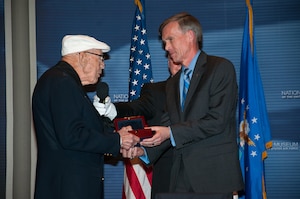 Doolittle Raider Lt. Col. Richard Cole presents the Raiders’ Congressional Gold Medal to Museum Director Lt. Gen. (Ret.) John Hudson. The medal is on display in the museum’s World War II Gallery in the Doolittle Raid exhibit. (U.S. Air Force photo by Niki Jahns)