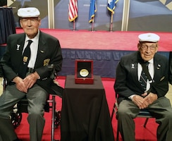 Doolittle Raiders Lt. Col. Richard Cole, co-pilot of Crew No. 1, and Staff Sgt. David Thatcher, engineer-gunner of Crew No. 7, with the Congressional Gold Medal. The medal is on display in the museum’s World War II Gallery in the Doolittle Raid exhibit. (U.S. Air Force photo)