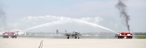 B-25 “Panchito,” owned by Larry Kelley and Lorie Thomsen, arrives at Wright-Patterson AFB following a ceremonial flight with the Doolittle Raiders Congressional Gold Medal on board. The aircraft was welcomed with a water arch by the Wright-Patterson AFB Fire Department. (U.S. Air Force photo by Will Haas)