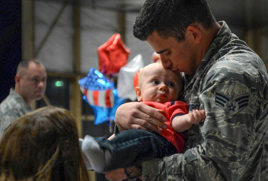 A U.S. Air Force Airman assigned to the 20th Fighter Wing returns from a deployment at Shaw Air Force Base, S.C., April 18, 2015. Approximately 200 Airmen deployed to the United States Central Command AOR for six month. (U.S. Air Force photo by Senior Airman Jensen Stidham/Released)