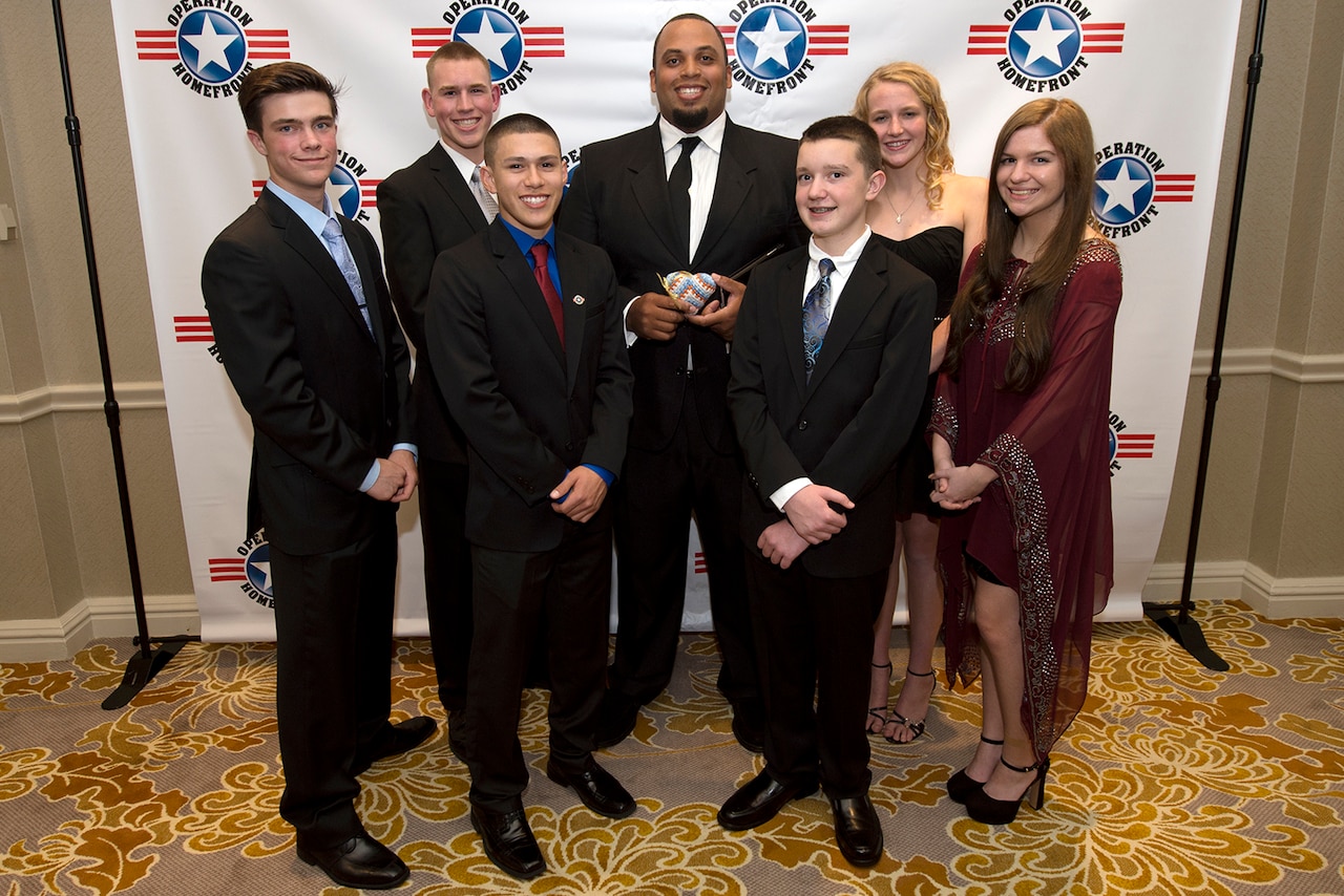 Military Child of the Year Award recipients stand with former professional athlete Jason Brown, center, before the award ceremony April 16, 2015 in Arlington, Va. From left are Zach Parsons, Caleb Parsons, Christopher-Raul Rodriguez, Brown, Cavan McIntyre-Brewer, Emily Kliewer, and Sarah Hesterman. DoD photo by EJ Hersom
