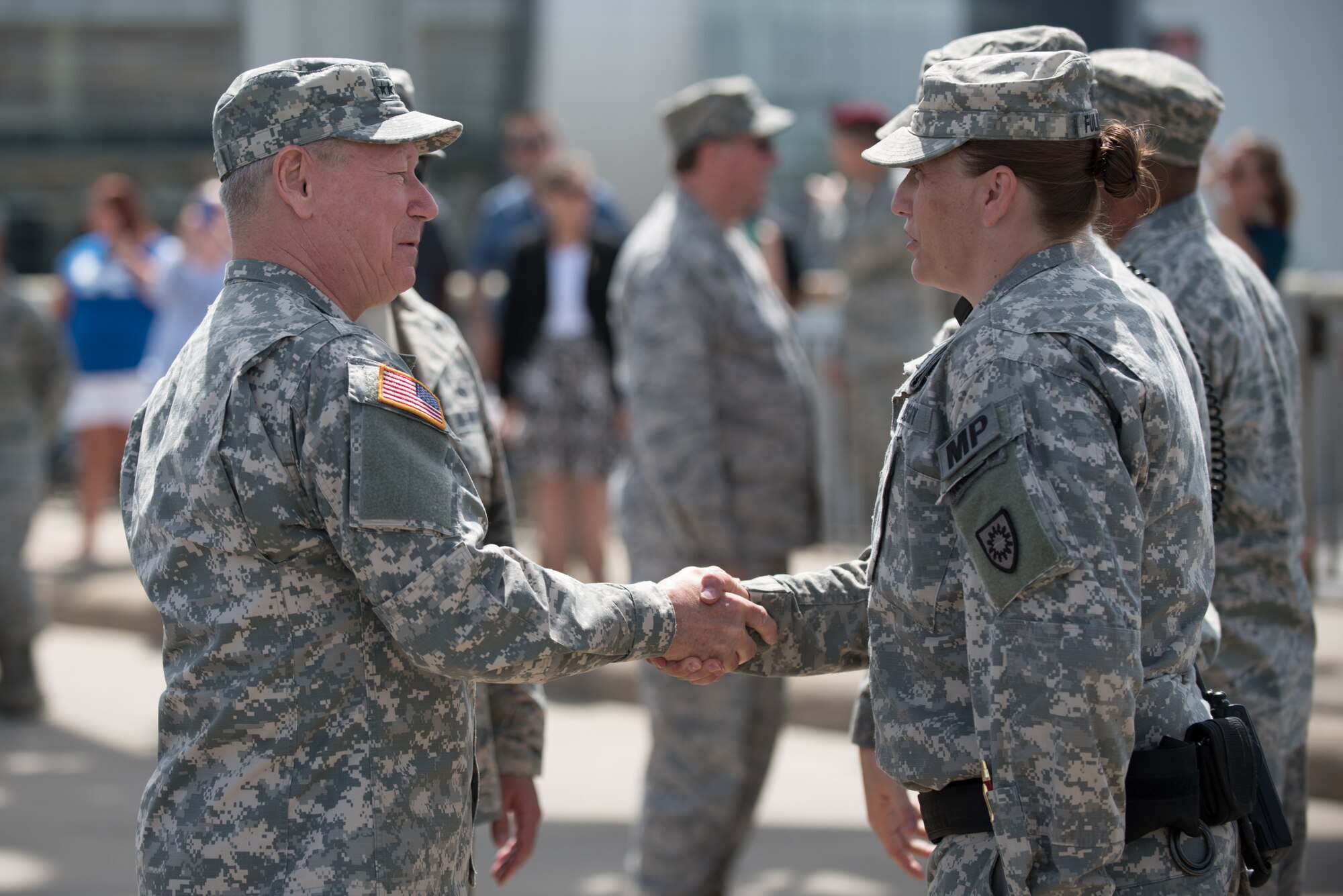Army Gen. Frank J. Grass, chief of the National Guard Bureau, speaks to a Soldier from the Kentucky Army National Guard after a mass swearing-in ceremony on the Clark Memorial Bridge in downtown Louisville, Ky., April 18, 2015. Grass administered the oath of enlistment during the ceremony, which kicked off the Thunder Over Louisville air show. (U.S. Air National Guard photo by Maj. Dale Greer)