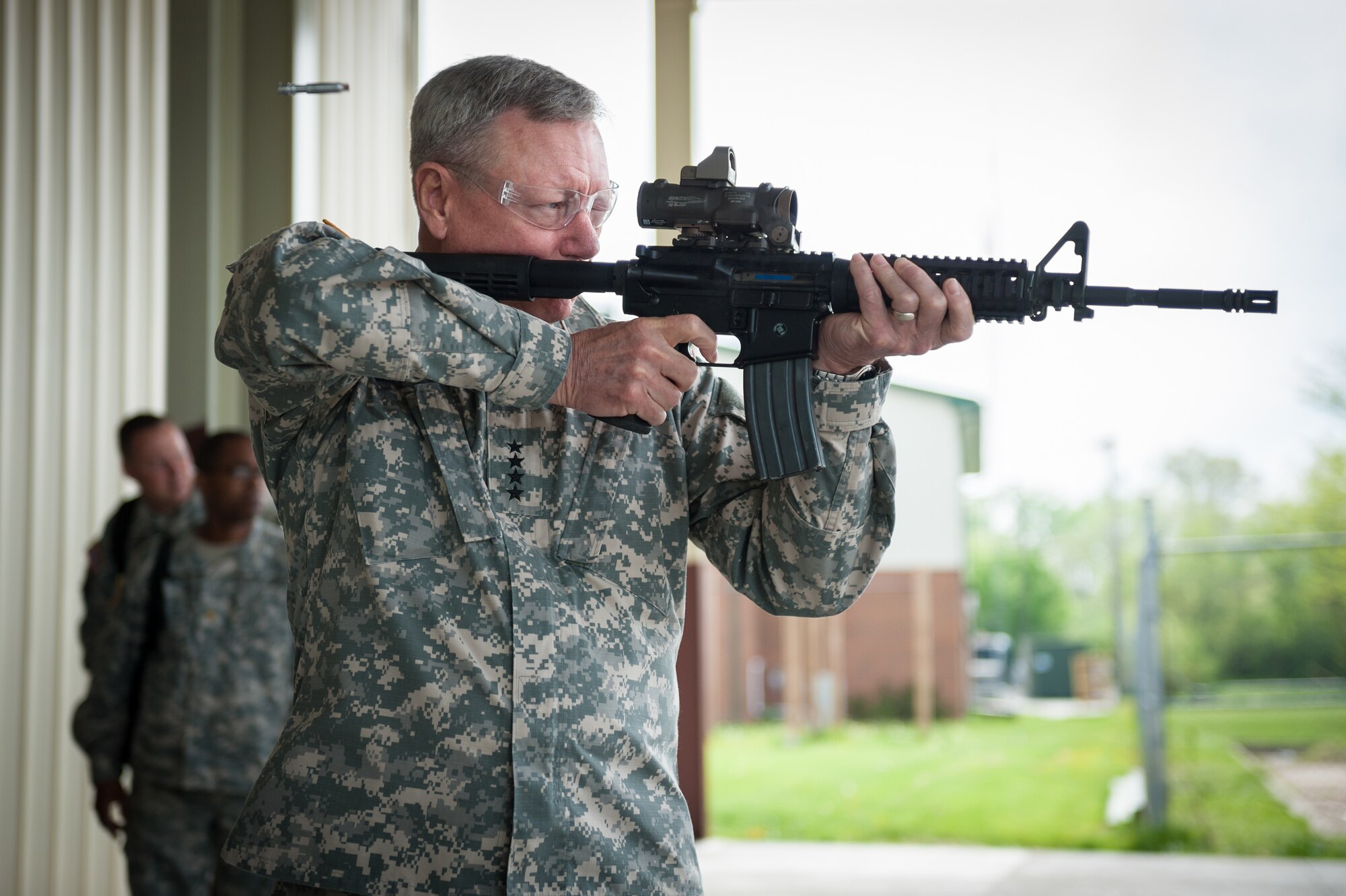 Army Gen. Frank J. Grass, chief of the National Guard Bureau, fires an M-4 rifle loaded with paint ball simunitions during a mission brief on the 123rd Special Tactics Squadron at the Kentucky Air National Guard Base in Louisville, Ky., April 18, 2015. The 123rd is the only special tactics unit in the Air National Guard with both combat controllers and pararescuemen. (U.S. Air National Guard photo by Maj. Dale Greer)