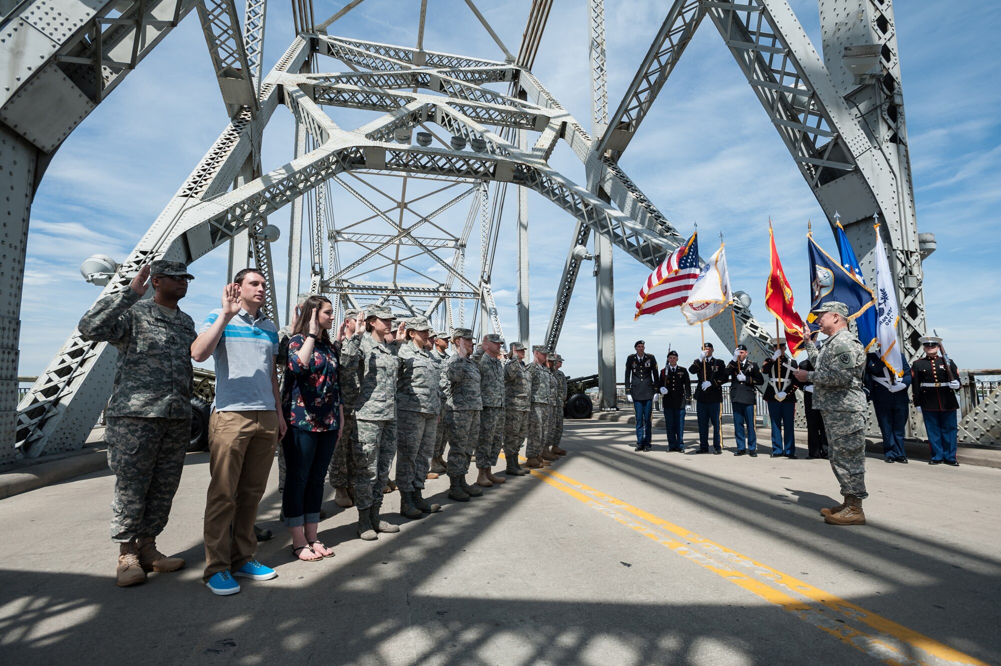 Army Gen. Frank J. Grass, chief of the National Guard Bureau, swears in 20 Soldiers and Airmen from the Kentucky National Guard during a re-enlistment ceremony on the Clark Memorial Bridge in downtown Louisville, Ky., April 18, 2015. The event, televised live, kicked off the 2015 Thunder Over Louisville air show. (U.S. Air National Guard photo by Maj. Dale Greer)