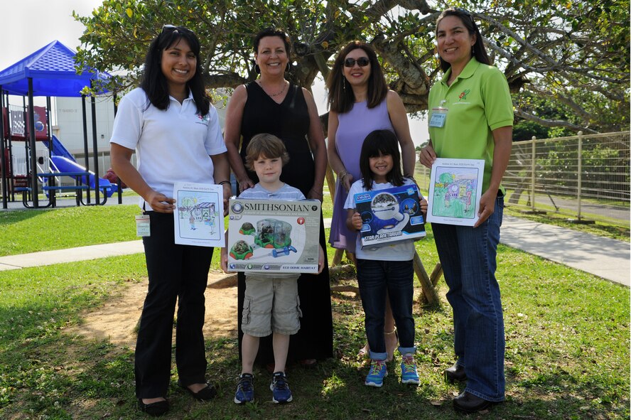 Students from Bob Hope Primary School show off their winning artwork and prizes with representatives from the 718th Civil Engineer Squadron environmental office, their teacher and their school’s principal on Kadena Air Base, Japan, April 17, 2015. The students participated in the 718th CES environmental flight’s Earth Day art contest, which was open to students from all schools on Kadena and aimed to get the base’s younger residents excited about conserving the Earth’s resources. (U.S. Air Force photo by Airman 1st Class Zade C. Vadnais)