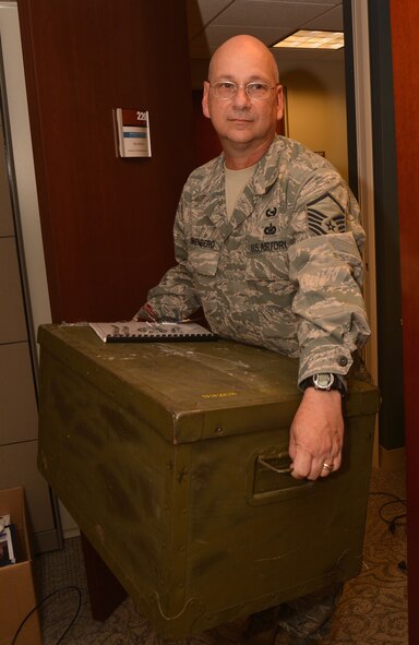 Master Sgt. Gerald Sonnenberg, 932nd Wing Historian, moves a large trunk during an office swap with the inspector general's office. Sergeant Sonnenberg is now located in room 220 of Wing Headquarters.  (U.S. Air Force photo/ Staff Sgt. Amber Hodges)