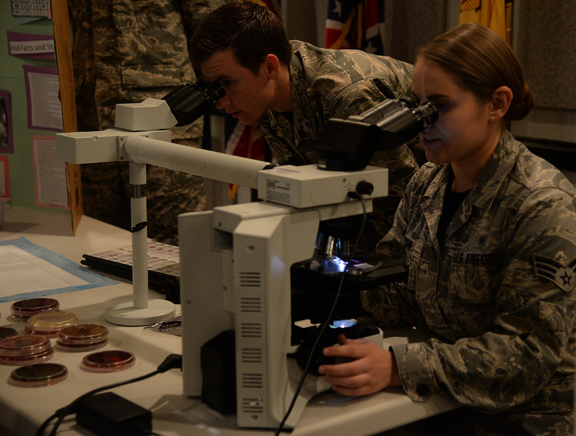 Senior Airman Tayla Ashe, 81st Diagnostics and Therapeutics Squadron technician, shows bacteria through a microscope to a student of a Southeast and Southwest Region Air Force ROTC Detachment during the medical one-on-one discussion portion of the “Pathways to Blue” diversity outreach event April 17, 2015, Keesler Air Force Base, Miss. Hosted by 2nd Air Force, the event provides a way to demonstrate Keesler’s and Air Education and Training Command’s technical and flight training capabilities while informing cadets about career choices available in the Air Force when deciding what path to take after college. (U.S. Air Force photo by Senior Airman Holly Mansfield)
