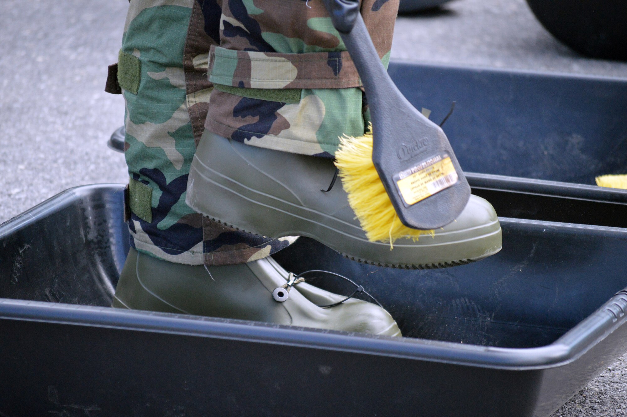 Airmen go through the decontamination procedures during hands-on chemical, biological, radiological and nuclear training at Stratton Air National Guard Base, New York, on April 18, 2015. The training was part of the 109th Airlift Wing's first ancillary training rodeo where more than 200 Airmen were trained on CBRN as well as self-aid and buddy care. (U.S. Air National Guard photo by Tech. Sgt. Catharine Schmidt/Released)