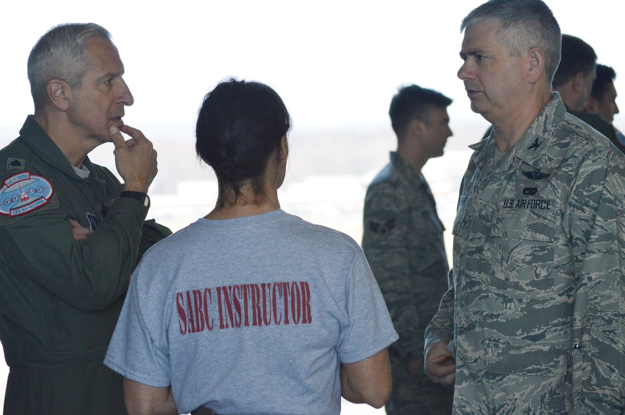 Lt. Col. Alan Ross, 109th Airlift Wing vice commander (left), and Col. Shawn Clouthier, 109th AW commander, talk with Master Sgt. Candace Stefanik, 109th AW self-aid buddy care adviser, during the hands-on SABC portion of the 109th Airlift Wing's first ancillary training rodeo April 18, 2015. More than 200 Airmen went through the training which also included chemical, biological, radiological and nuclear training. (U.S. Air National Guard photo by Tech. Sgt. Catharine Schmidt/Released)