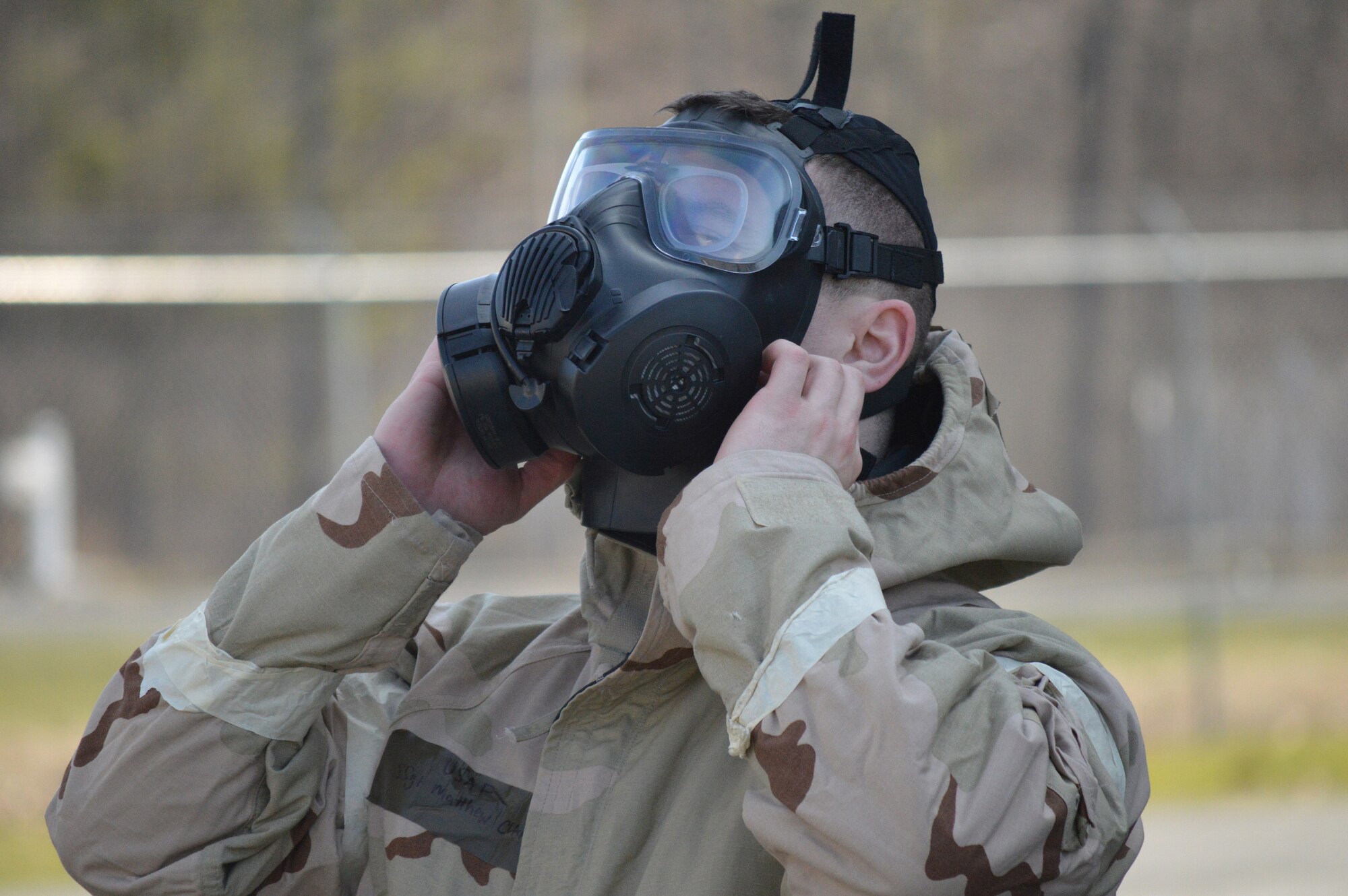 Staff Sgt. Matthew Clancy, 109th Logistics Readiness Squadron, takes off his mask during the hands-on chemical, biological, radiological and nuclear training at Stratton Air National Guard Base, New York, on April 18, 2015. The training was part of the 109th Airlift Wing's first ancillary training rodeo where more than 200 Airmen were trained on CBRN as well as self-aid and buddy care. (U.S. Air National Guard photo by Tech. Sgt. Catharine Schmidt/Released)