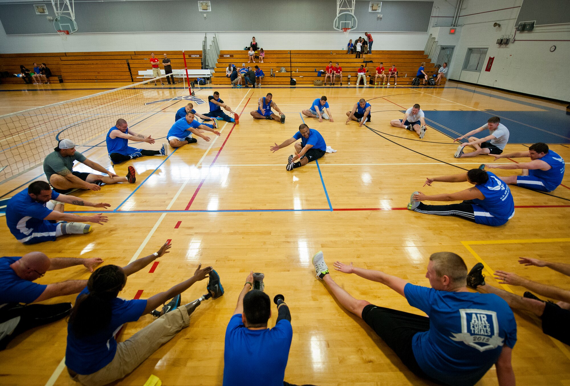 An Air Force Wounded Warrior coach leads the athletes in a stretching session during the first day of the Warrior Games training camp at Eglin Air Force Base, Fla., April 18. The five-day training camp for the Air Force’s athletes serves as their last practice session before the Warrior Games June 19-28. (U.S. Air Force photo/Samuel King Jr.)