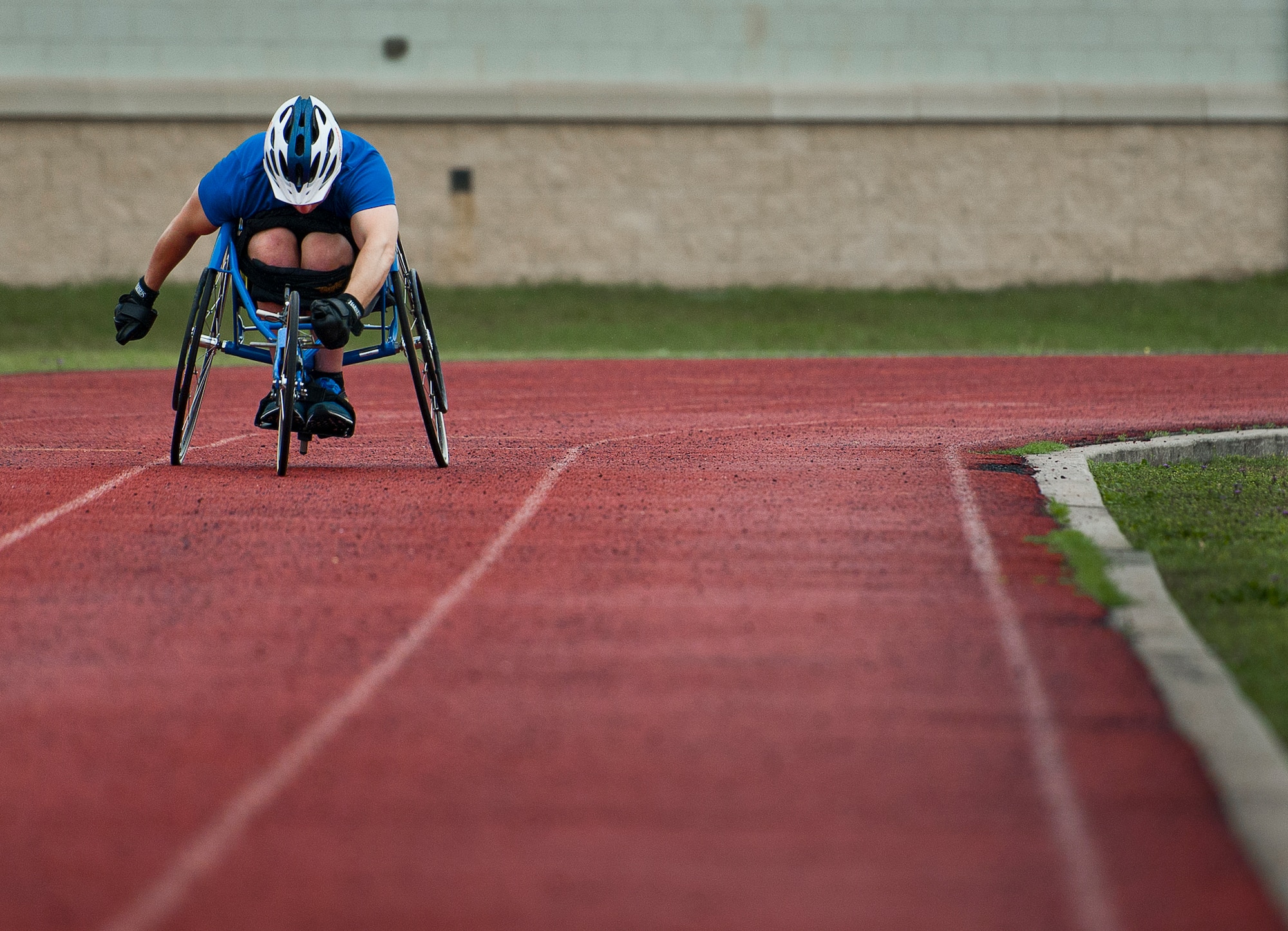 Jesse Graham, an Air Force Wounded Warrior athlete, rolls down the track in a sport-chair during the first day of the Warrior Games training camp at Eglin Air Force Base, Fla., April 18. The five-day training camp for the Air Force’s athletes serves as their last practice session before the Warrior Games June 19-28. (U.S. Air Force photo/Samuel King Jr.)
