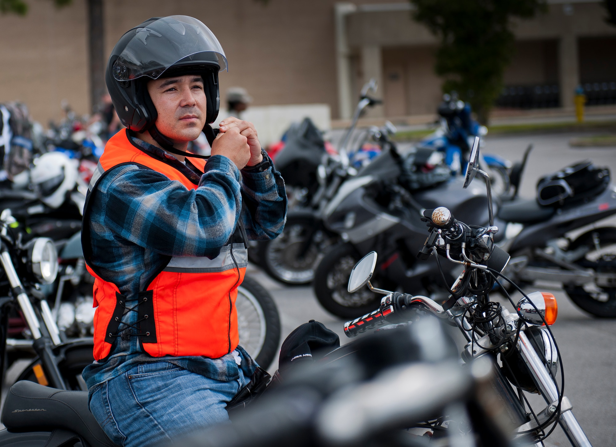 A rider puts on his helmet and safety gear after the base’s annual motorcycle safety rally April 17 at Eglin Air Force Base, Fla.  Approximately 600 civilian and military riders rode in for the joint 53rd Wing/96th Test Wing event.  (U.S. Air Force photo/Samuel King Jr.)