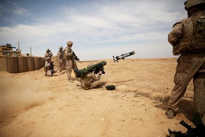 U.S. Marine Cpl. Patrick J. Whyte, a anti-tank missileman with 2nd Battalion, 7th Marine Regiment, Task Force Al Asad, fires a FGM-148 Javelin missile at simulated enemy armored targets during a combined-arms training exercise at Al Asad Air Base, Iraq, April 3, 2015. Elements from Golf and Weapons Companies combined their skills and capabilities to suppress and destroy their objective. (U.S. Marine Corps Photo by Cpl. Carson Gramley/Released)