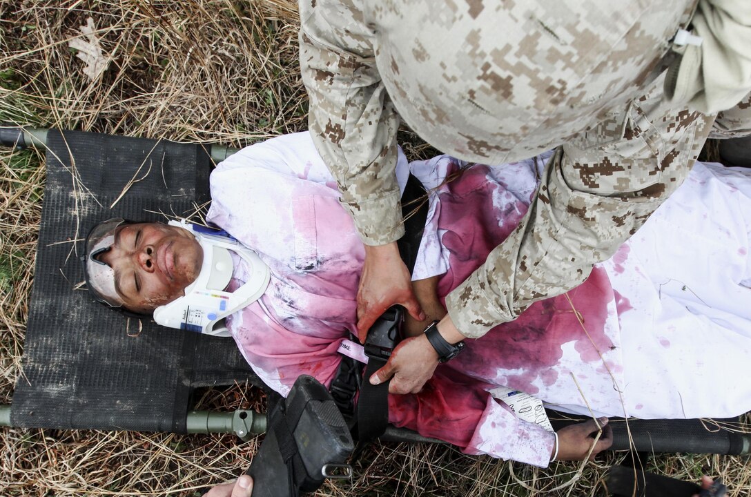 U.S. Marines and Sailors with Combat Logistics Battalion 26, 26th Marine Expeditionary Force, rehearse mass casualty evacuation drills during the unit's realistic urban training at Fort Pickett, Va., April 15, 2015. The 26th MEU is conducting realistic urban training in preparation for deployment in the 5th and 6th Fleet areas of responsibility later this year. (U.S. Marine Corps photo by Staff Sgt. Bobby J. Yarbrough/Released)