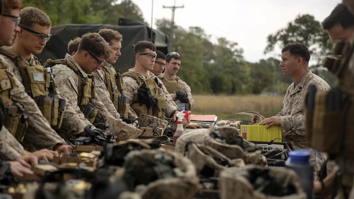 Marines with 2nd Platoon, 2nd Force Reconnaissance Company, II Marine Expeditionary Force are instructed on the course of fire before participating in a live-fire exercise during a close-quarters combat tactics course at range K-501A aboard Marine Corps Base Camp Lejeune, N.C., April 14, 2015. Marines built upon training in techniques and tactics in preparation for the 22nd Marine Expeditionary Unit slated to deploy in 2016.