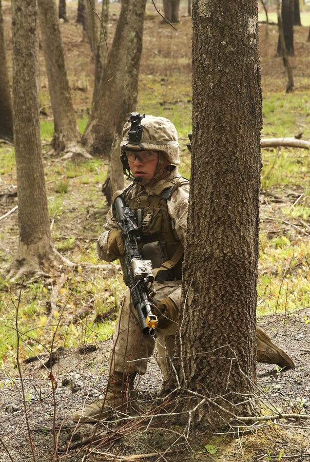 A Marine with Light Armored Reconnaissance, Battalion Landing Team 2/6, 26th Marine Expeditionary Unit, waits for the signal to move forward as part of a simulated raid aboard Fort Pickett, Va., April 16, 2015. Marines simulated a raid on a Military Operations in Urban Terrain (MOUT) training town as part of their Realistic Urban Training. During the training, Marines were tasked with clearing the objective building as well as detaining role-players and egressing out of the town. During this, the Marines reacted to simulated casualties and realistic changes of mission objectives. (Official U.S. Marine Corps photo by Lance Cpl. Dalton A. Precht)