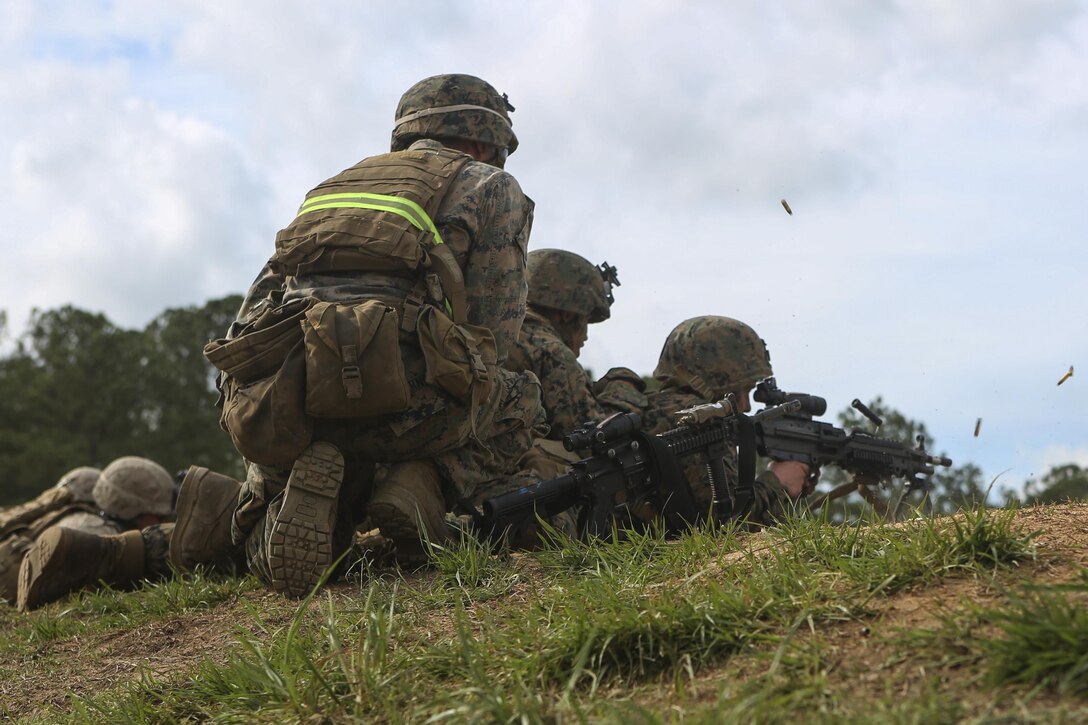 U.S. Marines with Golf Company, Battalion Landing Team 2/6, 26th Marine Expeditionary Unit (MEU), fire on targets with an M249 light machine gun during an infantry platoon battle course at Fort Pickett, Va., April 17, 2015. The 26th MEU and its supporting elements are conducting realistic urban training in preparation for deployment to the 5th and 6th Fleet areas of responsibility later this year. (U.S. Marine Corps photo by Cpl. Joshua W. Brown/Released)