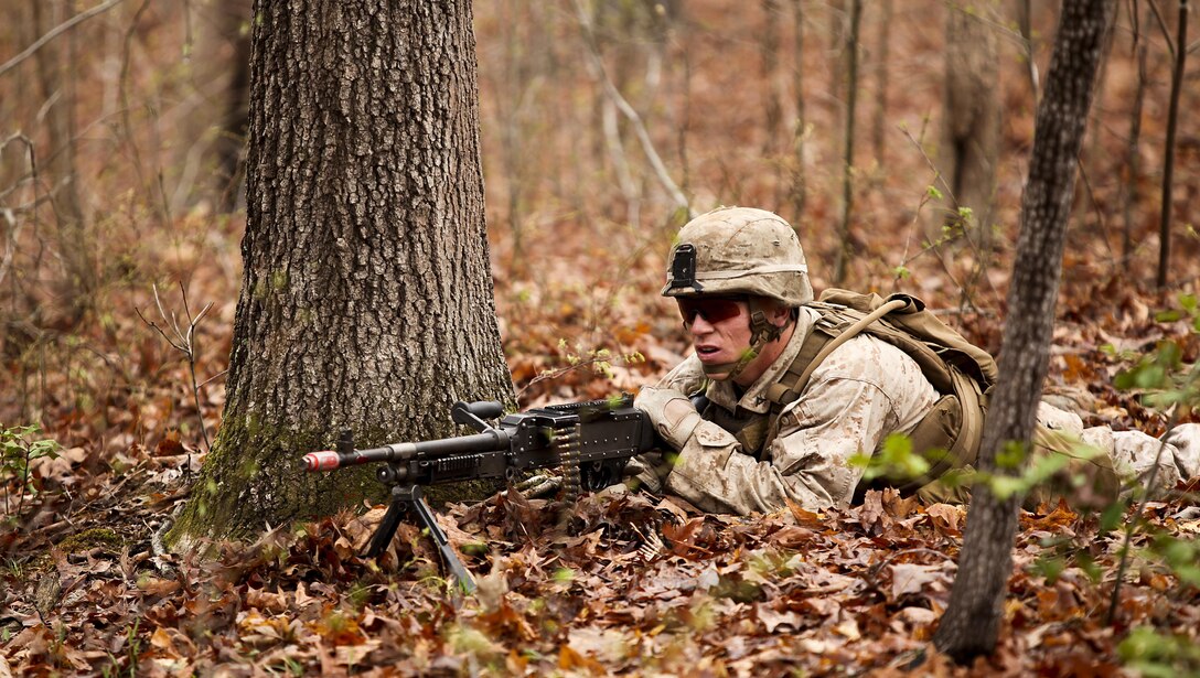 A U.S. Marine with Fox Company, Battalion Landing Team 2/6, 26th Marine Expeditionary Force, provide cover fire as an assault team prepares to enter a building during military operations in urban terrain (MOUT) training at Fort Pickett, Va., April 11, 2015. The 26th MEU is conducting realistic urban training in preparation for deployment in the 5th and 6th Fleet areas of responsibility later this year. (U.S. Marine Corps Photo by Staff Sgt. Bobby J. Yarbrough/Released)
